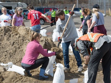 The community of Constance Bay, Ont. gets busy filling sandbags and using them to protect tehir homes in anticipation of rising water from the Ottawa River.