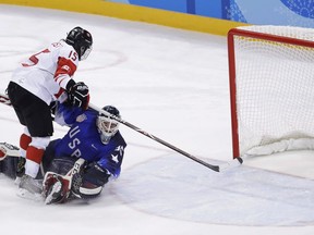 Melodie Daoust (15), of Canada, scores a goal past goalie Maddie Rooney (35), of the United States, in the penalty shootout during the women's gold medal hockey game at the 2018 Winter Olympics in Gangneung, South Korea, Thursday, Feb. 22, 2018. Had the final score been different, Daoust's shootout goal would be more celebrated in Canadian hockey history.