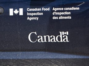 A Canadian Food Inspection Agency logo is seen on a truck on Sept. 27, 2007 northwest of Regina. The Canadian Food Inspection Agency says it will launch a months-long consultation process this year on setting a maximum level of arsenic allowed in food, including baby cereal. Currently, there is no hard limit on arsenic in food in Canada and the U.S., despite existing regulations in Europe.