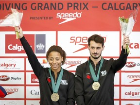 Jennifer Abel and François Imbeau-Dulac celebrate their victory following the mixed three-metre synchro finals event at the FINA Diving Grand Prix in Calgary on April 7, 2019.