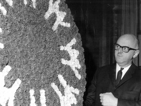 Montreal Mayor Jean Drapeau gazes at a gift from florists to mark Expo 67's opening day, April 27, 1967.