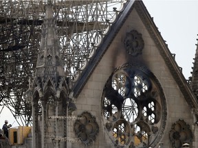 A worker checks on a wooden support structure placed on the Notre Dame Cathedral in Paris, Wednesday, April 17, 2019. Nearly $1 billion has already poured in from ordinary worshippers and high-powered magnates around the world to restore Notre Dame Cathedral in Paris after a massive fire.