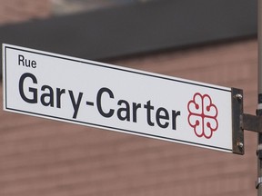 A sign for Rue Gary Carter is shown in Montreal, Tuesday, April 2, 2019. As rumours about professional baseball's return to Montreal continue to percolate, sharp-eyed visitors to the city can find tributes to its rich baseball past. Patrick Carpentier, a historian who heads the Quebec chapter of the Society for American Baseball Research, says Montreal is very much a hockey town, so you've got to travel a little farther and look a little more closely to find those spots.