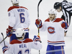 Montreal Canadiens' Jordan Weal (43) and Andrew Shaw (65) celebrate Weal's empty-net goal against the Jets in Winnipeg on March 28, 2019.