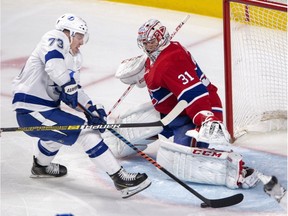 Montreal Canadiens goaltender Carey Price stops Tampa Bay Lightning left-winger Adam Erne during third-period action on Tuesday, April 2, 2019, in Montreal.