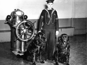 In a photo dated May 2, 1942, Harry Tibbles holds two black Newfoundland dogs who were mascots to HMCS Montreal, a Royal Canadian Naval Volunteer Reserve "ship" on Mountain St. in Montreal.