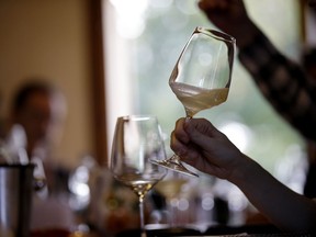 An expert wine tester shakes a glass of Prosecco during a wine testing at the Case Paolin farm, in Volpago del Montello, Italy.