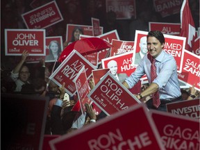 Liberal Leader Justin Trudeau greets supporters as he takes the stage during a rally Sunday, October 4, 2015 in Brampton, Ont.