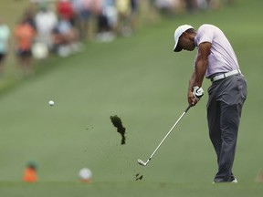 Tiger Woods hits his fairway shot on No. 1 during the third round of the Masters golf tournament Saturday, April 13, 2019, at Augusta National in Augusta, Ga. (Curtis Compton/Atlanta Journal-Constitution via AP) ORG XMIT: GAATJ328