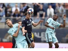 Montreal Impact's Samuel Piette, centre, heads the ball past the defence of Philadelphia Union's Kacper Przybylko, left, and Fafa Picault during the second half of an MLS soccer match on Saturday, April 20, 2019, in Chester, Pa. The Union won 3-0.