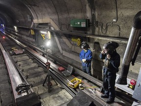 A Société de transport de Montreal (STM) maintenance crew work on a track during the early hours of the morning in Montreal, Thursday, April 11, 2019.