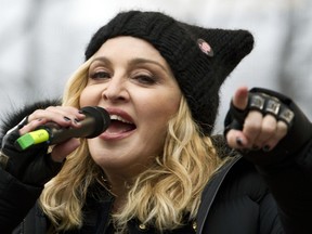 FILE - In this Jan. 21, 2017 file photo, Madonna performs on stage during the Women's March rally in Washington.   Madonna and Colombian singer Maluma will bring their new collaboration to life when they perform at next month's Billboard Music Awards.  NBC and dick clark productions announced Friday, April 19, 2019 that the duo will sing "Medellin" at the May 1 event in Las Vegas.