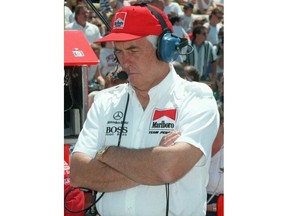 FILE - In this May 20, 1995, file photo, car owner Roger Penske stands in the pit area at the Indianapolis Motor Speedway during the third day of qualifications for the Indianapolis 500 at Indianapolis Motor Speedway in Indianapolis. Defending champion Al Unser Jr. and Emerson Fittipaldi failed to qualify. Chip Ganassi and Michael Andretti have joined Roger Penske in calling for guaranteed spots in the Indianapolis 500. The team owners argue their financial commitment to IndyCar is too steep to afford missing out on the biggest race of the year.