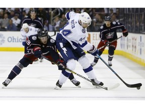 Columbus Blue Jackets' Pierre-Luc Dubois, left, and Tampa Bay Lightning's Jan Rutta, of the Czech Republic, fight for a loose puck during the second period of Game 4 of an NHL hockey first-round playoff series, Tuesday, April 16, 2019, in Columbus, Ohio.