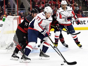 Lucas Wallmark of the Carolina Hurricanes defends against T.J. Oshie of the Washington Capitals at PNC Arena on April 18, 2019, in Raleigh, North Carolina.