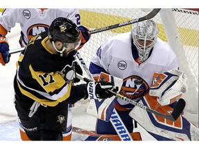 Pittsburgh Penguins' Bryan Rust (17) can't get to a rebound off New York Islanders goaltender Robin Lehner (40) during the first period in Game 4 of an NHL first-round hockey playoff series in Pittsburgh, Tuesday, April 16, 2019.