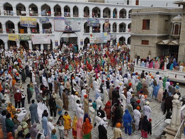 Sikh pilgrims pray during the Vasakhi festival, at the shrine of Gurdwara Punja Sahib, the second most sacred place for Sikhs, in Hasan Abdal, some 50 kilometers (31 Miles) from Islamabad, Pakistan, Sunday, April 14, 2019. Thousands of Sikh pilgrims arrived from neighboring India and other countries to attend the harvest festival that is regionally known by many names and marks the Solar New Year.
