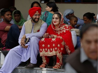 A newlywed Sikh couple attends the Vasakhi festival, at the shrine of Gurdwara Punja Sahib, the second most sacred place for Sikhs, in Hasan Abdal, some 50 kilometers (31 Miles) from Islamabad, Pakistan, Sunday, April 14, 2019. Thousands of Sikh pilgrims arrived from neighboring India and other countries to attend the harvest festival that is regionally known by many names and marks the Solar New Year.
