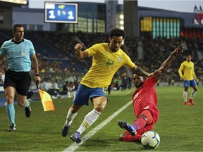 Panama's Omar Browne, bottom, tackles Brazil's Felipe Anderson during a friendly at Dragao Stadium in Porto, Portugal on March 23, 2019.