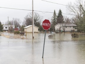 A residential street is surrounded by floodwaters in Rigaud on Friday, April 19, 2019.