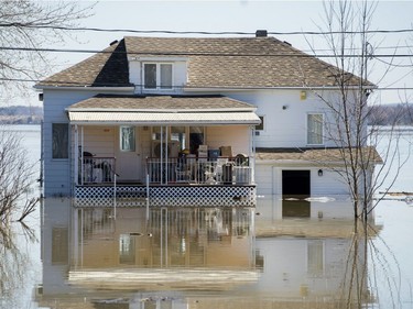 A house is shown surrounded by floodwaters in Hudson, west of Montreal, Monday, April 22, 2019.