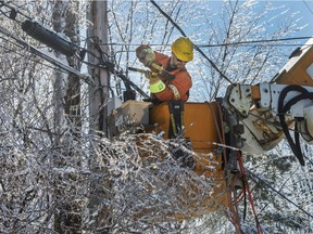 Hydro Quebec workers repair power lines in Laval April 10, 2019, after an ice storm hit the area. Thousands of homes and businesses are still without power.