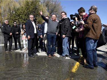 Quebec Premier Francois Legault speaks to Gatineau Mayor Maxime Pedneaud-Jobin at the edge of floodwaters on Rue Saint-Louis in Gatineau on Monday, April 22, 2019.