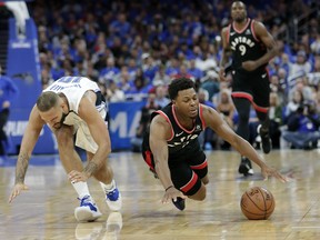 Toronto Raptors' Kyle Lowry, front right, falls to the floor after he is fouled by Orlando Magic's Evan Fournier, left, during the first half in Game 4 of a first-round NBA basketball playoff series, Sunday, April 21, 2019, in Orlando.