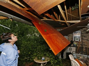 Sonya Banes looks at damage caused by a large oak tree that crashed through the ceiling of her mother's house in Learned, Miss., Thursday, April 18, 2019. Several homes were damaged by fallen trees in the tree lined community. Strong storms again roared across the South on Thursday, topping trees and leaving more than 100,000 people without power across Mississippi, Louisiana and Texas.