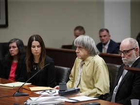 David Turpin, second from right, and his wife, Louise, far left, sit in a courtroom with their attorneys, Allison Lowe, second from left, and David Macher on Friday, Feb. 22, 2019, in Riverside, Calif. The California couple who shackled some of their 13 children to beds and starved them have pleaded guilty to torture and other abuse.