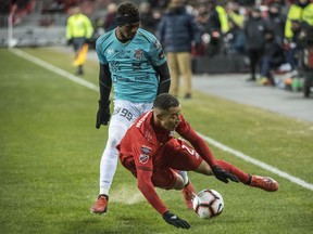 Toronto FC defender Justin Morrow (2) is tripped up by Omar Browne (99) during CONCACAF Champions League soccer action in Toronto in February 2019.