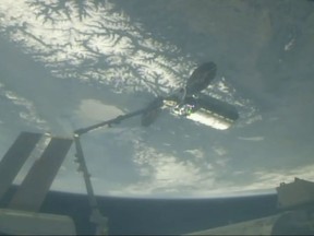 In this image taken from NASA Television, Cygnus capsule arrives at the International Space Station with food galore, following a 1 1/2-day journey from Virginia, Friday, April 19, 2019. Space station astronaut Anne McClain used a robot arm to capture the capsule as they soared 250 miles (402.32 kilometers) above Earth. (NASA TV via AP)