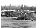 Disaster had struck the small community of Saint-Jean-Vienney in the Lac St. Jean region on May 4, 1971. This photo, published in the Montreal Gazette on May 6, 1971, shows two cars perched precariously on the edge of the embankment left by the landslide (see arrows).