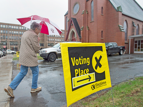 A voter arrives to cast her ballot in the Prince Edward Island provincial election at Saint Peter's Cathedral in Charlottetown on April 23, 2019.