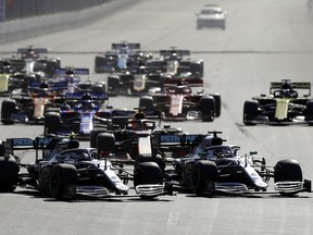 Mercedes driver Lewis Hamilton of Britain, right and Mercedes driver Valtteri Bottas of Finland, left, lead the field after the start during Formula One Grand Prix at the Baku Formula One city circuit in Baku, Azerbaijan, Sunday, April 28, 2019.