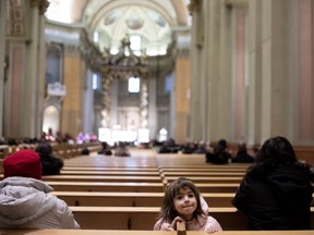 Chloe Sophia sits amid the empty pews at a recent mass at Mary Queen of the World Cathedral in downtown Montreal. Statistics Canada has reported a steep drop in religious observance in Quebec over the years.