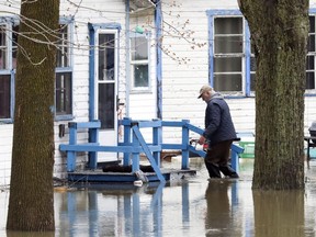 A man makes his way back to his chalet on Ile-Mercier in the Pierrefonds-Roboro borough of Montreal on Wednesday, April 24, 2019.