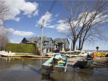 A boat sits in front of a home, nearest the lake,  that has escaped being flooded in Sainte-Marthe-sur-le-Lac, Quebec April 30, 2019.