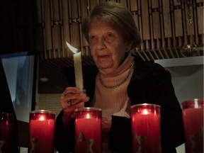Holocaust survivor Nettie Herscher holds a candle during a ceremony at the Tifereth Beth David Jerusalem Congregation in Côte-St-Luc Wednesday night.