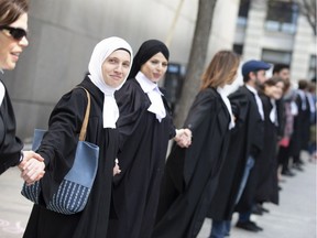 A group of protesters, including lawyers and teachers, against Bill 21 formed a human chain in downtown Montreal May 5, 2019.