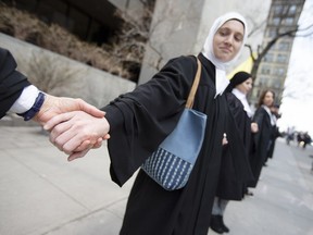 A group of protesters, including lawyers and teachers, against Bill 21 formed a human chain in downtown Montreal May 5, 2019.