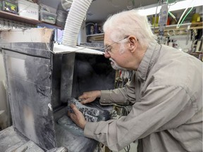Sculptor Dennis Partington works on a piece of granite in a workshop at his home in Beaconsfield.