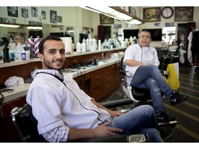 Mohammed Benaboud, left, and Mohamed Bouhalloufa are seen at the Albanese barber shop in Montreal on Wednesday, May 8, 2019.