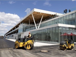 Crews pave pit row at the new F1 garage and paddock area in Montreal, on Wednesday, May 15, 2019.