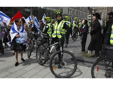 Not everyone was celebrating: Young protesters, part of an orthodox Jewish ant-zionist group supporting Palestinian sovereignty, jeer Israel Day celebrants on Peel St. in Montreal Thursday, May 9, 2019 during Yom Ha'atzmaut celebrations.