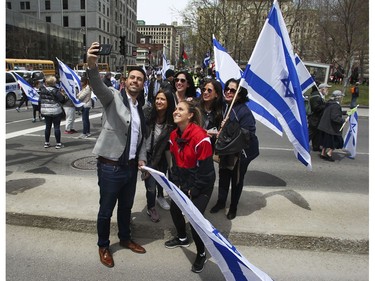 What's a parade without a selfie? Parade-watchers take a selfie on René-Lévesque Blvd. in Montreal Thursday, May 9, 2019 during Yom Ha'atzmaut celebrations marking the 71st Israel Independence Day.
