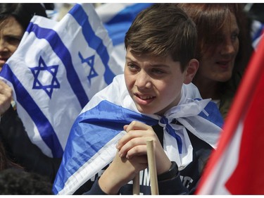 A young man listens to a speaker at Place du Canada in Montreal Thursday, May 9, 2019 during Yom Ha'atzmaut celebrations marking the 71st Israel Independence Day.