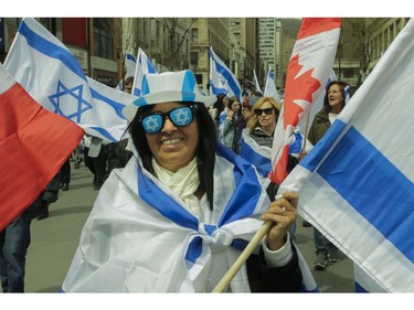 Sylvia Oiknine walks along Peel St. in Montreal Thursday, May 9, 2019 during Yom Ha'atzmaut celebrations marking the 71st Israel Independence Day.