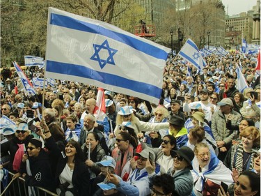 People celebrate at Place du Canada in Montreal Thursday, May 9, 2019 during Yom Ha'atzmaut celebrations marking the 71st Israel Independence Day.