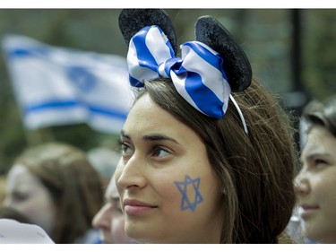 Danielle Kalfus, a volunteer from a Côte-St-Luc school (she is visiting from Israel to do her work) listens to a speaker at Place du Canada in Montreal Thursday, May 9, 2019 during Yom Ha'atzmaut celebrations marking the 71st Israel Independence Day.